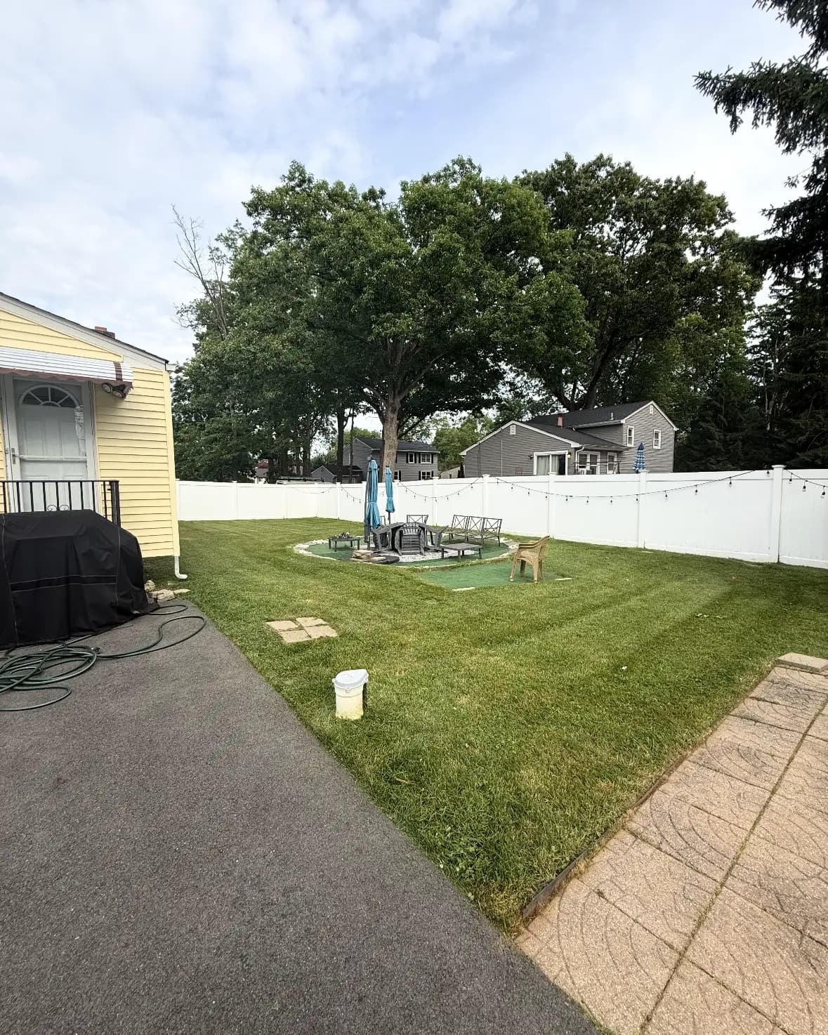 A backyard lawn mowed and edged along a walkway